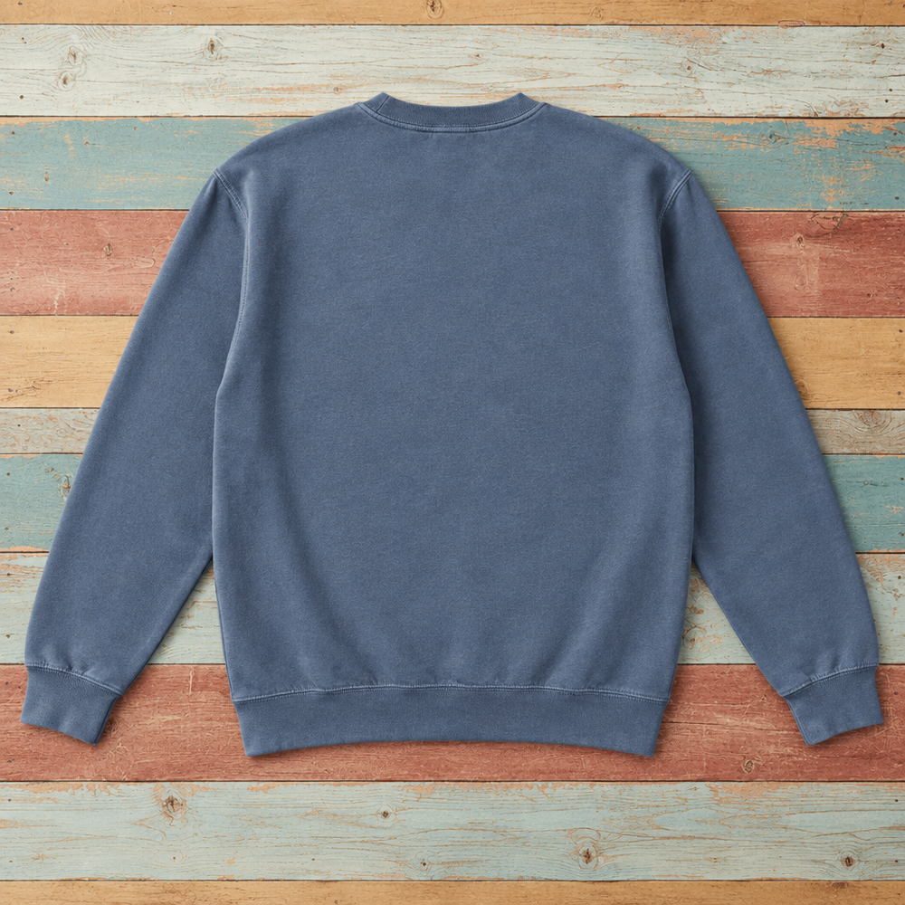 Plain back of Nags Head crewneck in Denim on colorful weathered driftwood boards