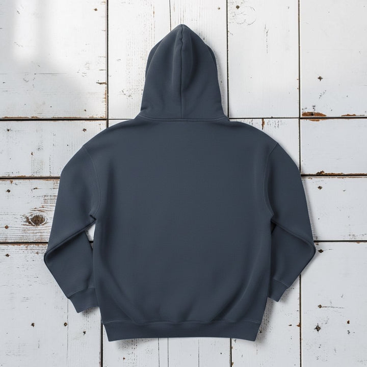 The Rusty Hook Hoodie in Steel Blue — back view, warm sand studio background