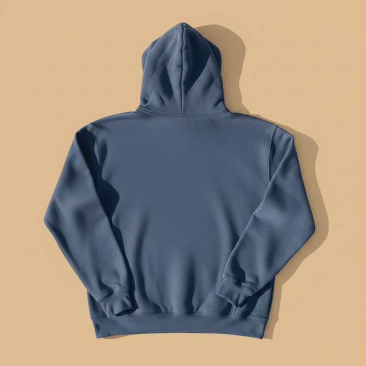 Coastal Lighthouse Hoodie in Denim — plain back, warm sand studio background