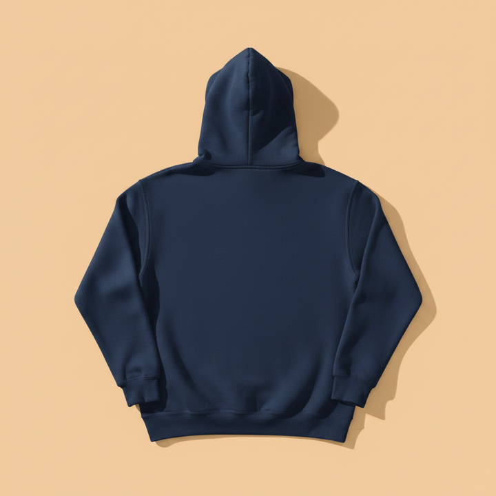 Coastal Lighthouse Hoodie in True Navy — plain back, warm sand studio background