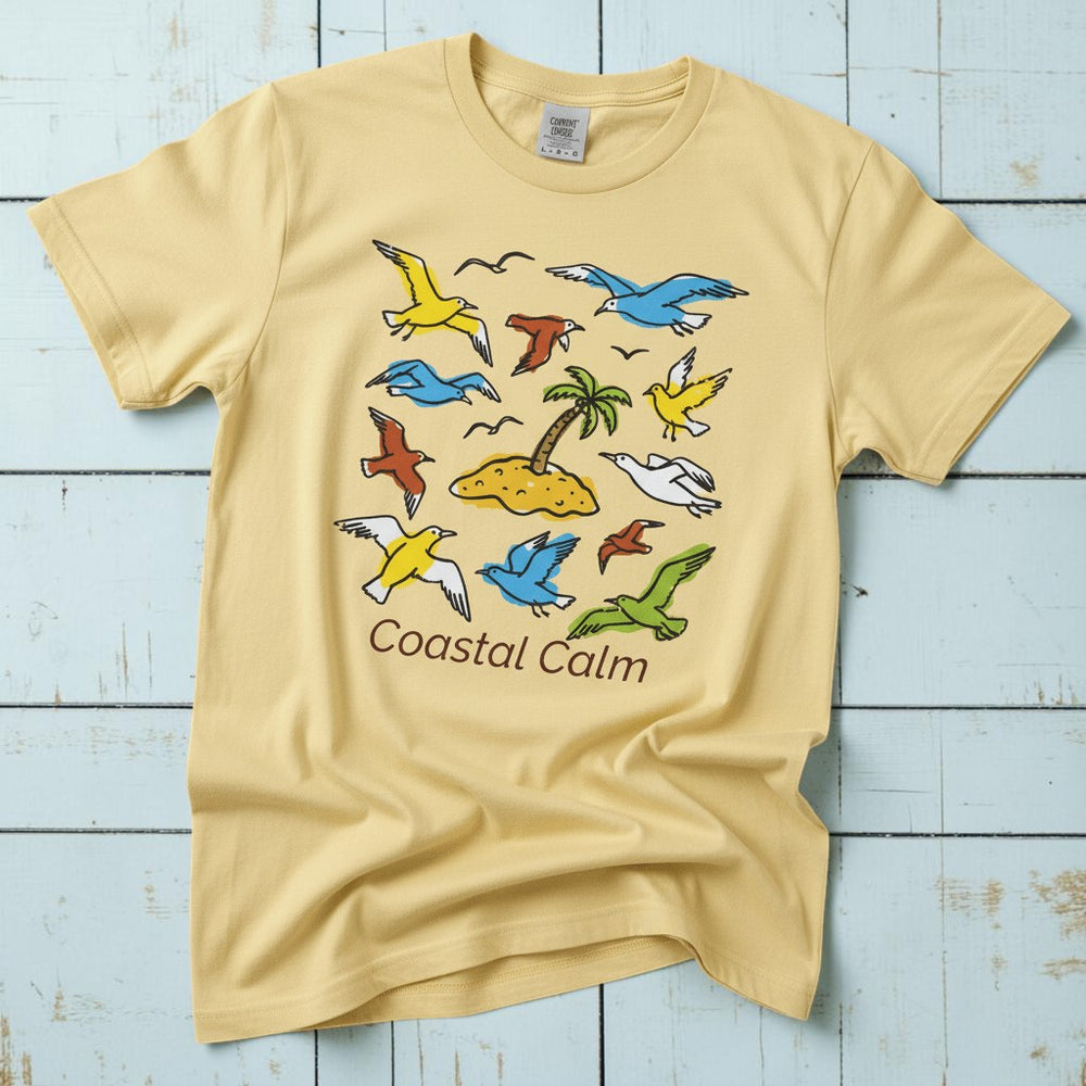 Coastal Calm Sea Birds Take Flight banana garment-dyed tee on faded driftwood planks