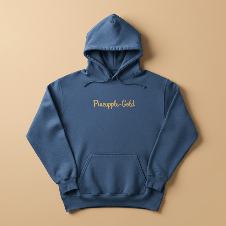 Pineapple-Gold Hoodie in True Navy — front chest graphic, warm sand studio background