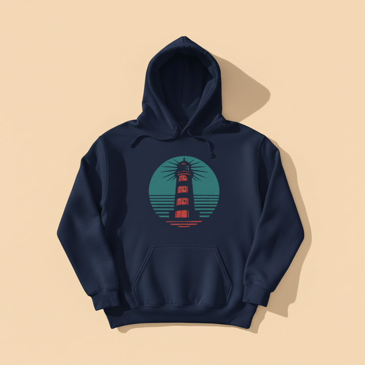 Coastal Lighthouse Hoodie in True Navy — front graphic, warm sand studio background