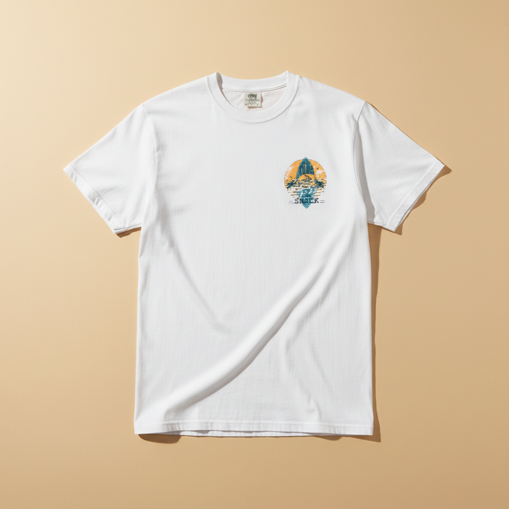 Hot Tuna Surf Shack Tee in White — front small chest graphic, warm sand studio background