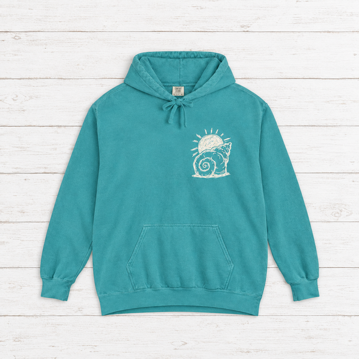 Beach Snail hoodie flat lay on whitewashed boards