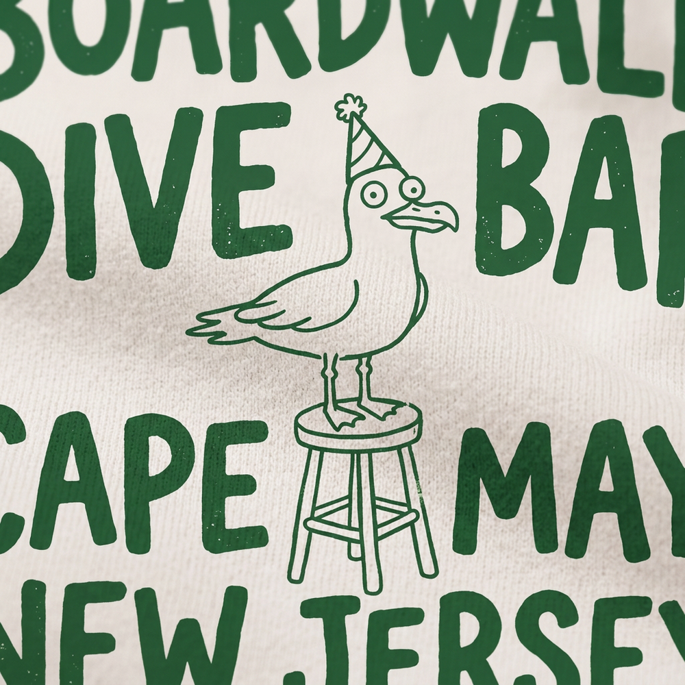 Cape May Dive Bar white hoodie green party hat seagull and bar stool graphic close-up