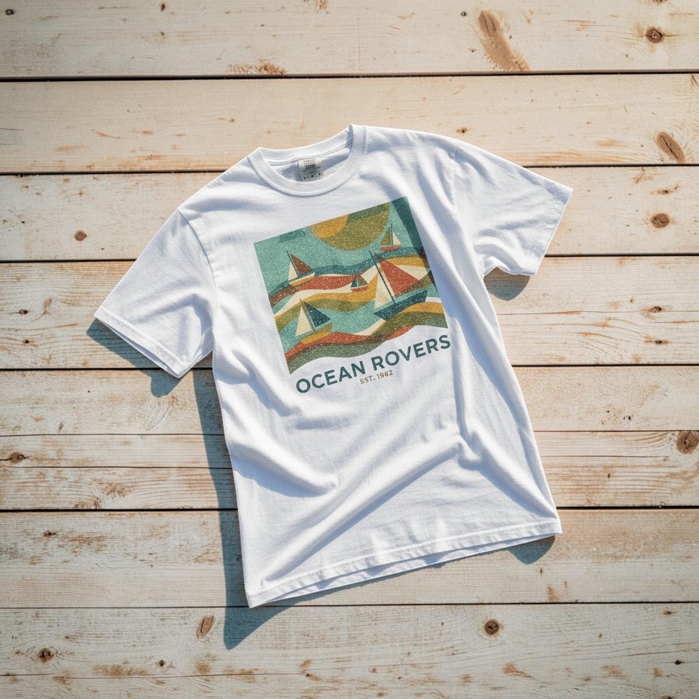 Ocean Rovers white garment-dyed tee on light cracked cement with wet marks