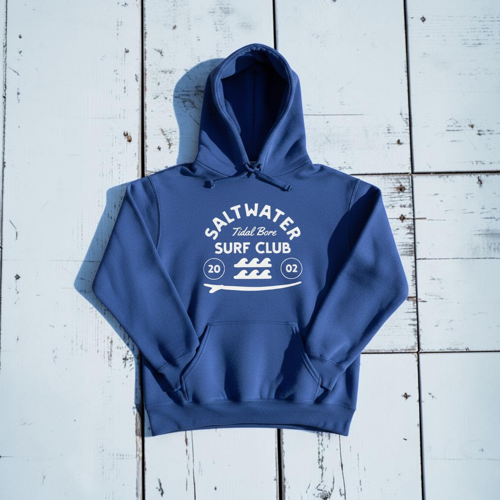 Saltwater Surf Club Hoodie in Flo Blue — front graphic, warm sand studio background
