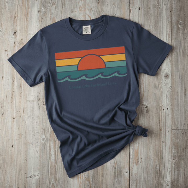 Coastal Calm for Inland Lives midnight garment-dyed tee on faded driftwood planks