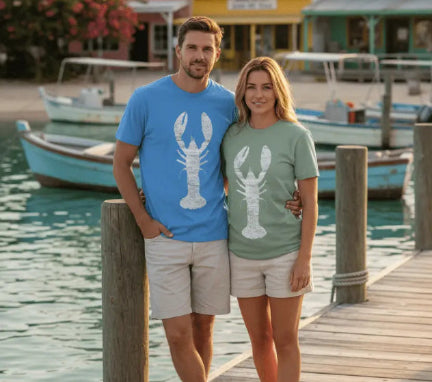 Man and woman standing on a dock by a waterfront with boats and colorful buildings in the background.