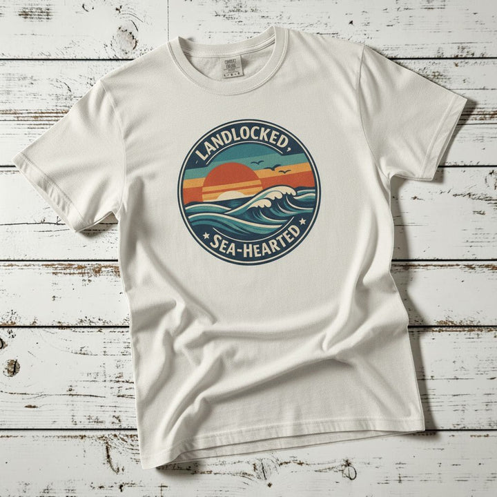 Landlocked Sea-Hearted Sunset white garment-dyed tee on faded driftwood planks