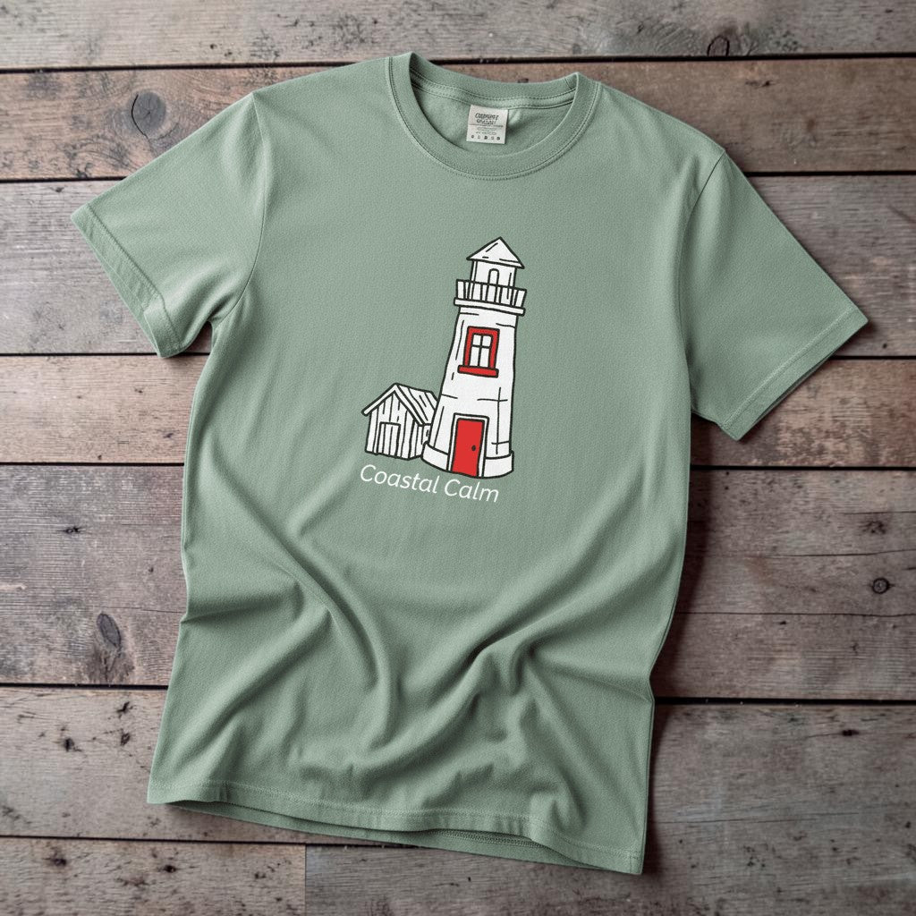 Lighthouse Coastal Calm light green garment-dyed tee on faded driftwood planks