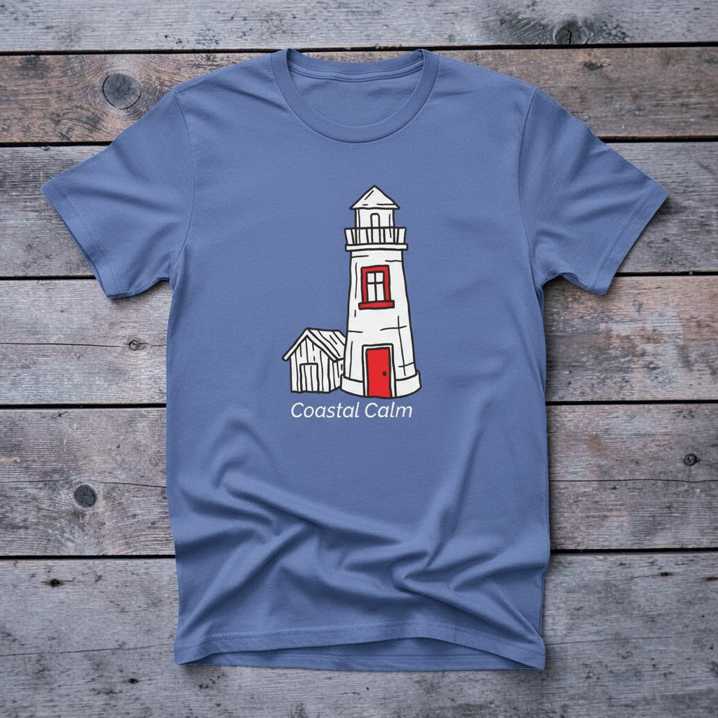 Lighthouse Coastal Calm mystic blue garment-dyed tee on faded driftwood planks