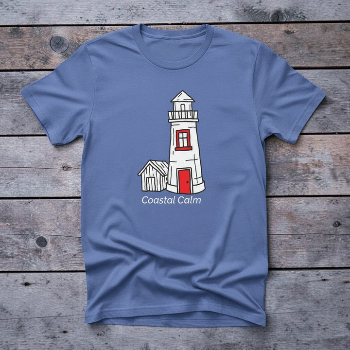 Lighthouse Coastal Calm mystic blue garment-dyed tee on faded driftwood planks