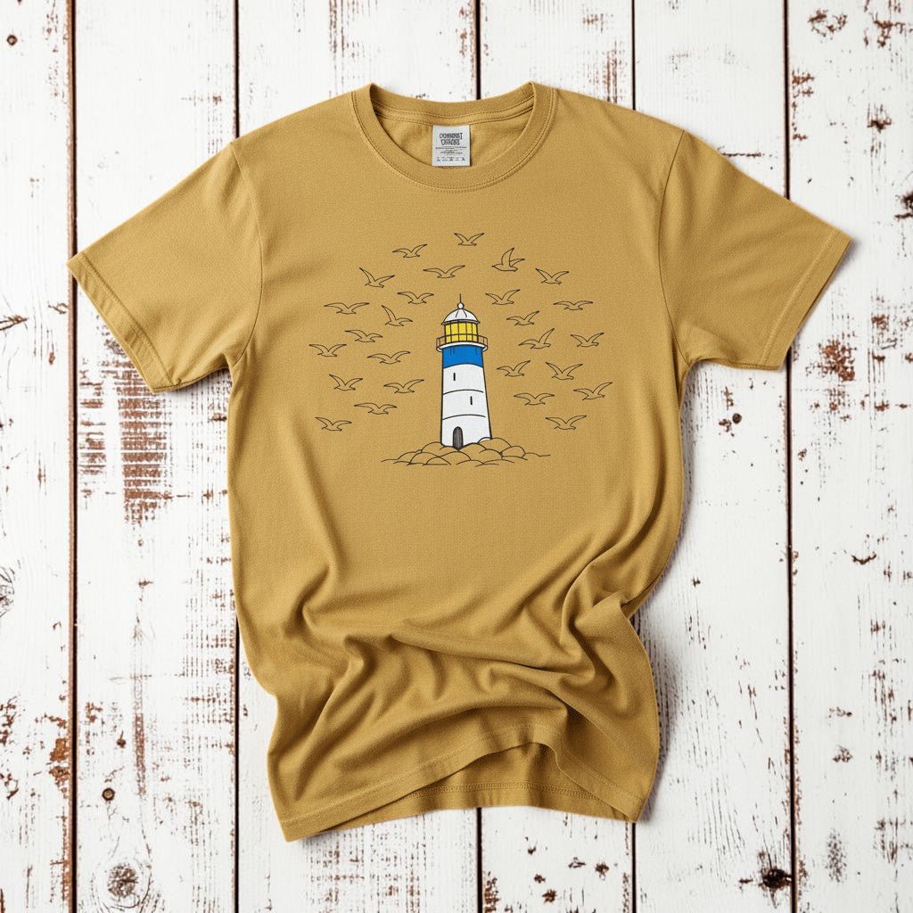 Lighthouse Coastal mustard garment-dyed tee on faded driftwood planks
