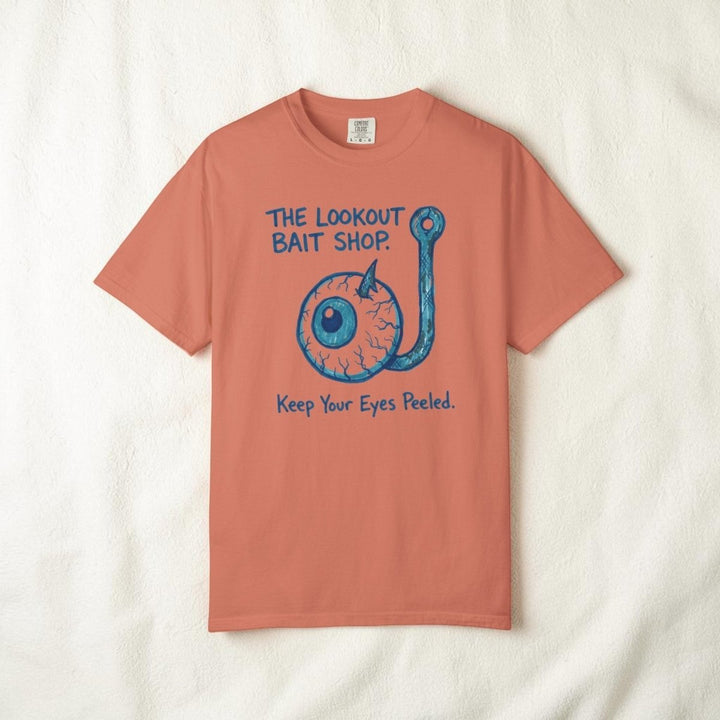 Coral t-shirt with blue fishing hook graphic and text on a white background