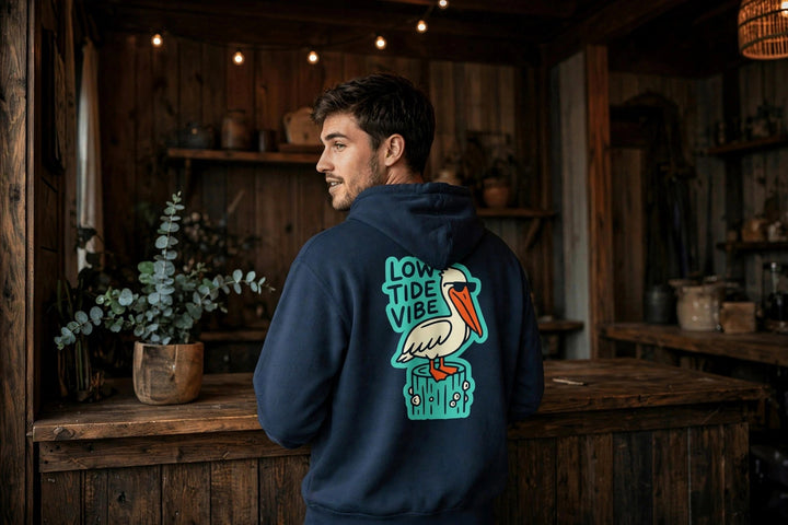 Low Tide Vibe Pelican Hoodie — in the Five Tides room, male back