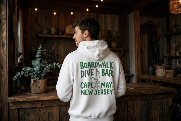 Cape May Dive Bar Hoodie — in the Five Tides room, male back