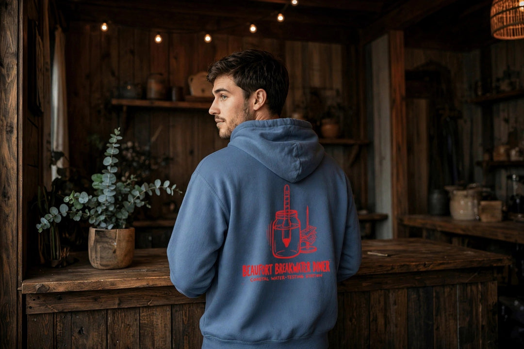 Beaufort Breakwater Diner Hoodie — in the Five Tides room, male back