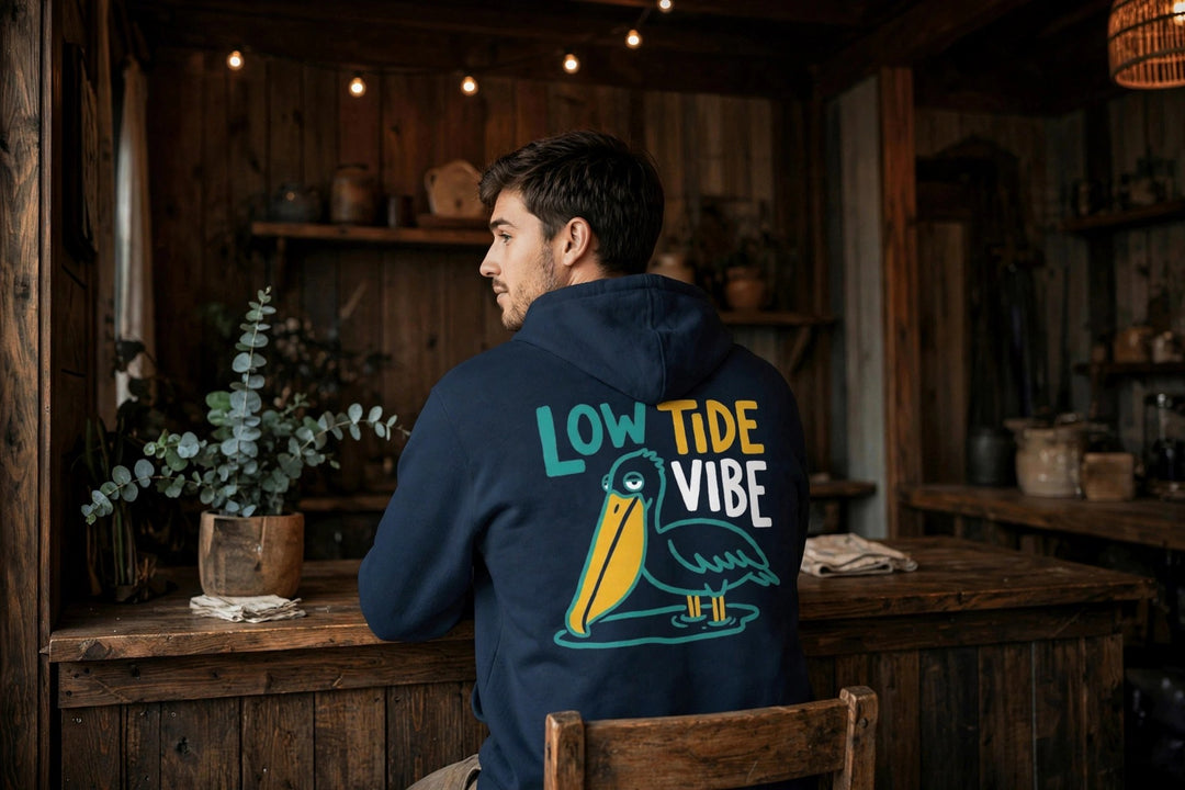 Low Tide Vibe Pelican Hoodie — in the Five Tides room, male back