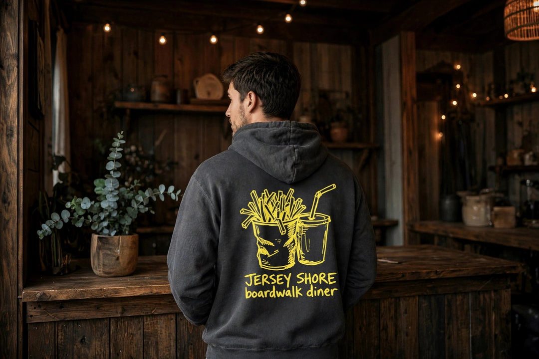 Boardwalk Diner Hoodie — in the Five Tides room, male back