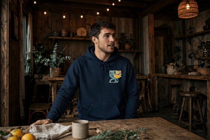 Low Tide Vibe Pelican Hoodie — in the Five Tides room, male front