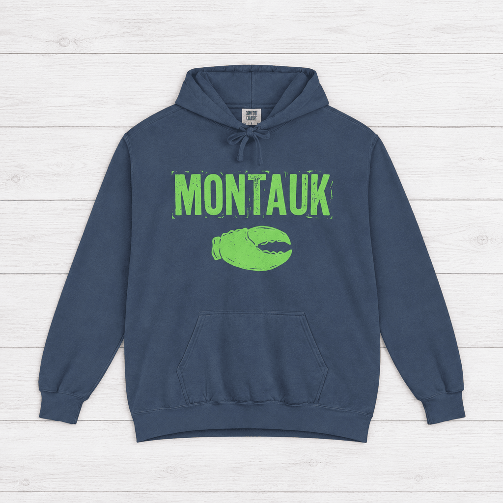 True Navy Montauk hoodie front with distressed neon-green lettering and lobster-claw graphic.