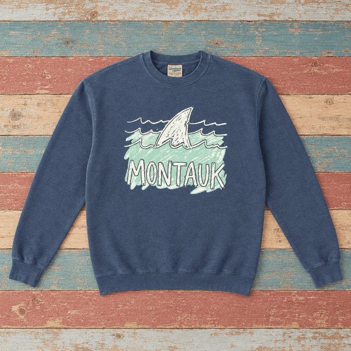 Montauk shark sweatshirt front in Denim with sea-green waves on colorful weathered driftwood boards