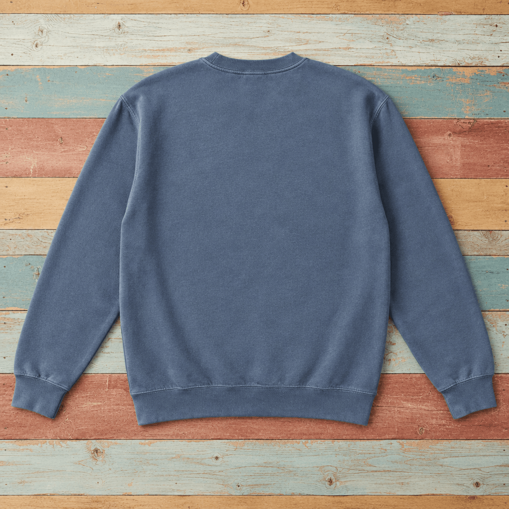 Plain back of Nags Head crewneck in Denim on colorful weathered driftwood boards