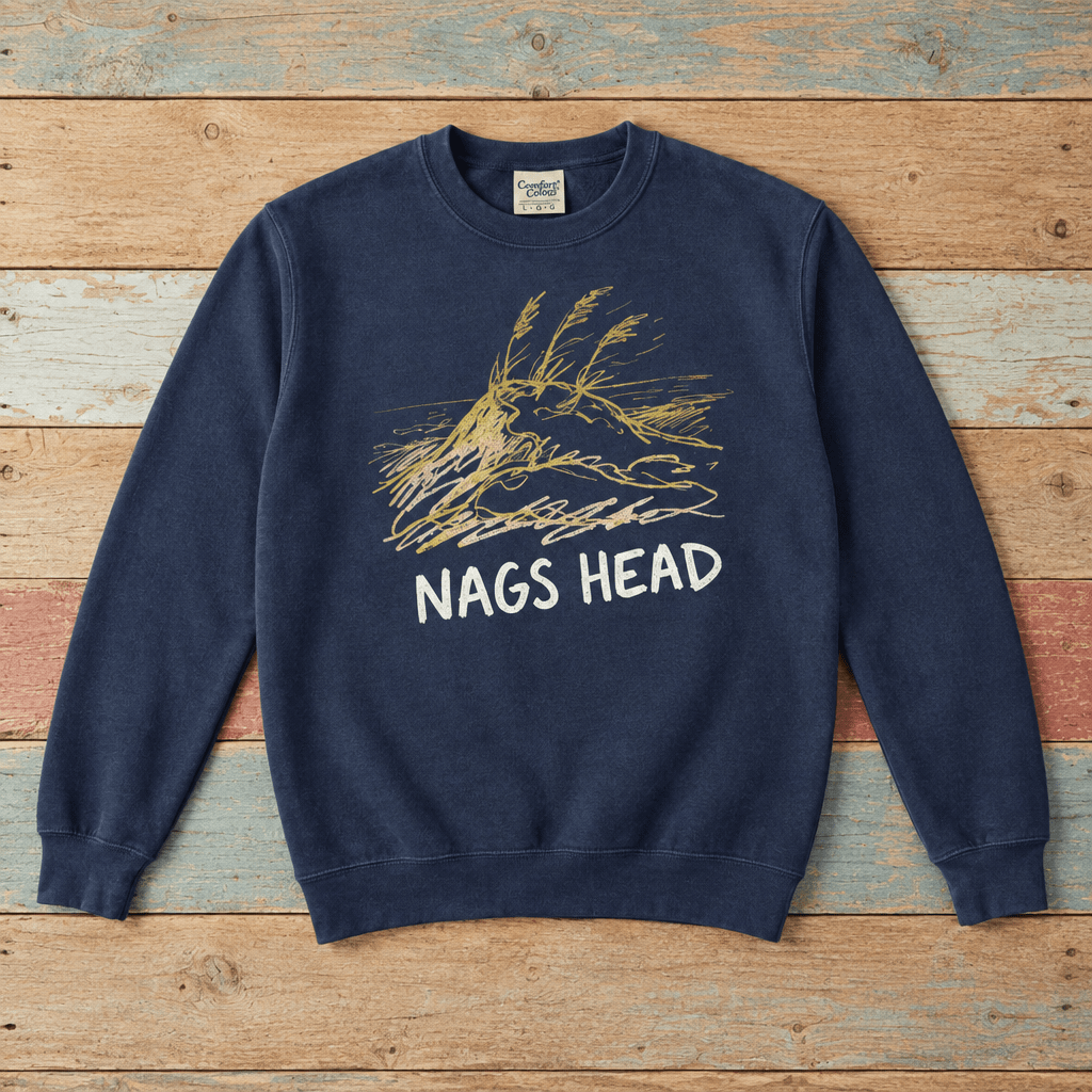 Nags Head crewneck front in True Navy with weathered-gold dune graphic on colorful weathered driftwood boards