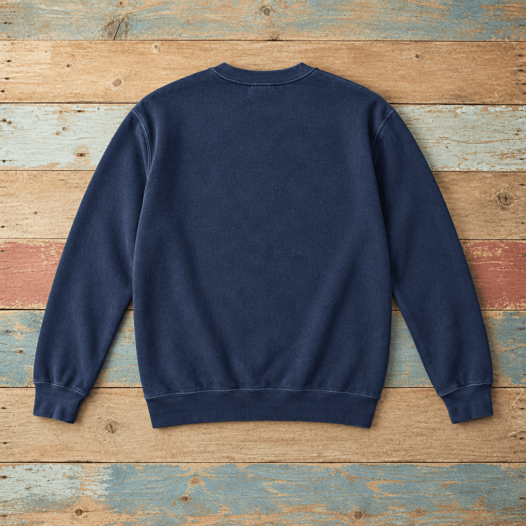 Plain back of Nags Head crewneck in True Navy on colorful weathered driftwood boards