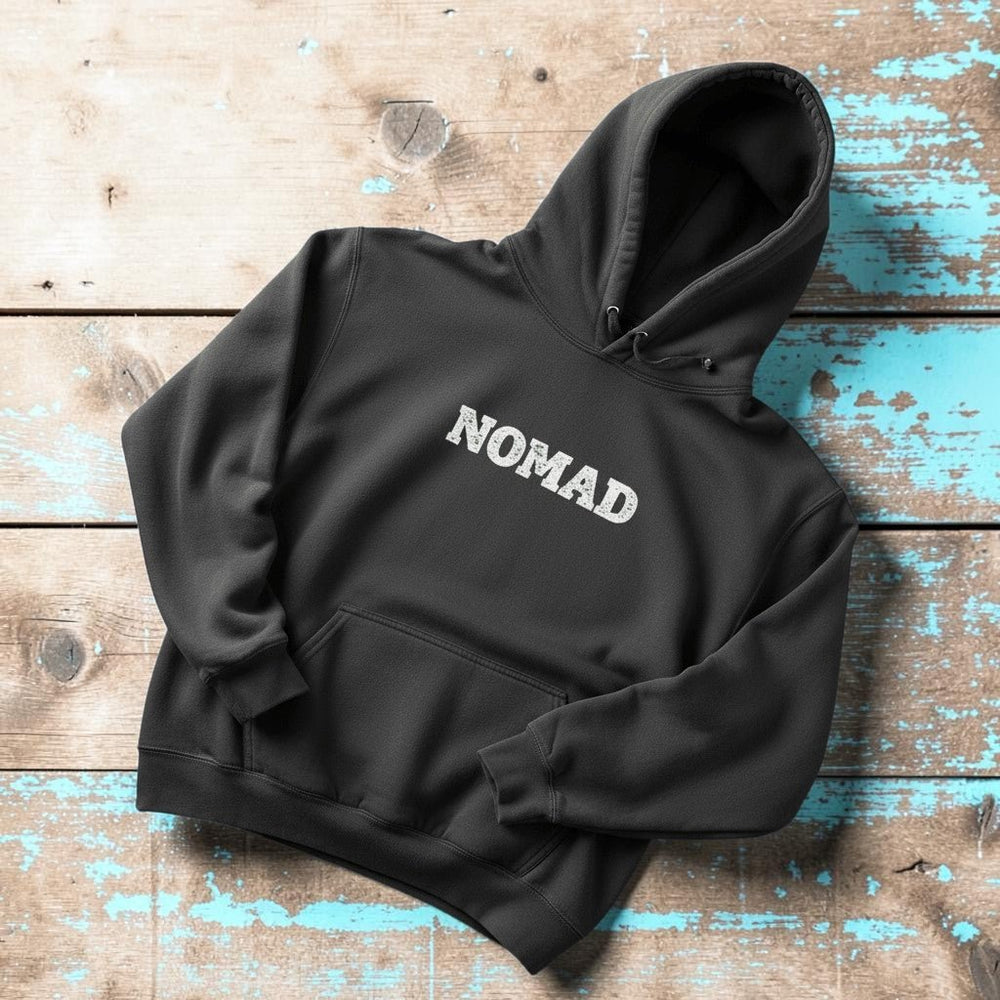 Nomad Garment-Dyed Hoodie in Pepper — front NOMAD chest graphic on driftwood