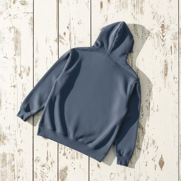 NOMAD Hoodie in Blue — plain back, warm sand studio background