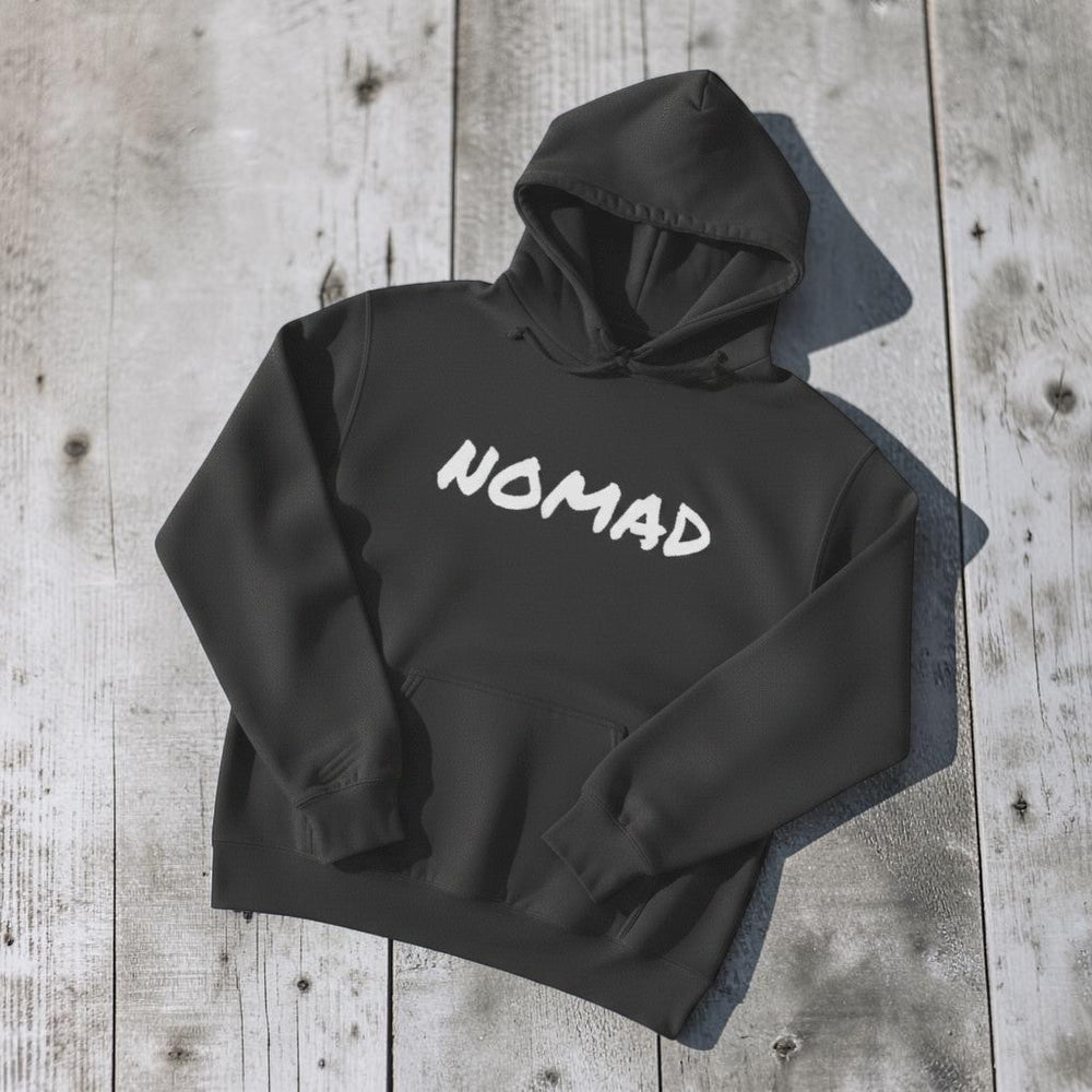 NOMAD Hoodie in Charcoal — front graphic, warm sand studio background