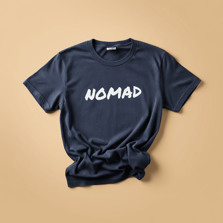 NOMAD Tee in China Blue/Navy — front graphic, warm sand studio background