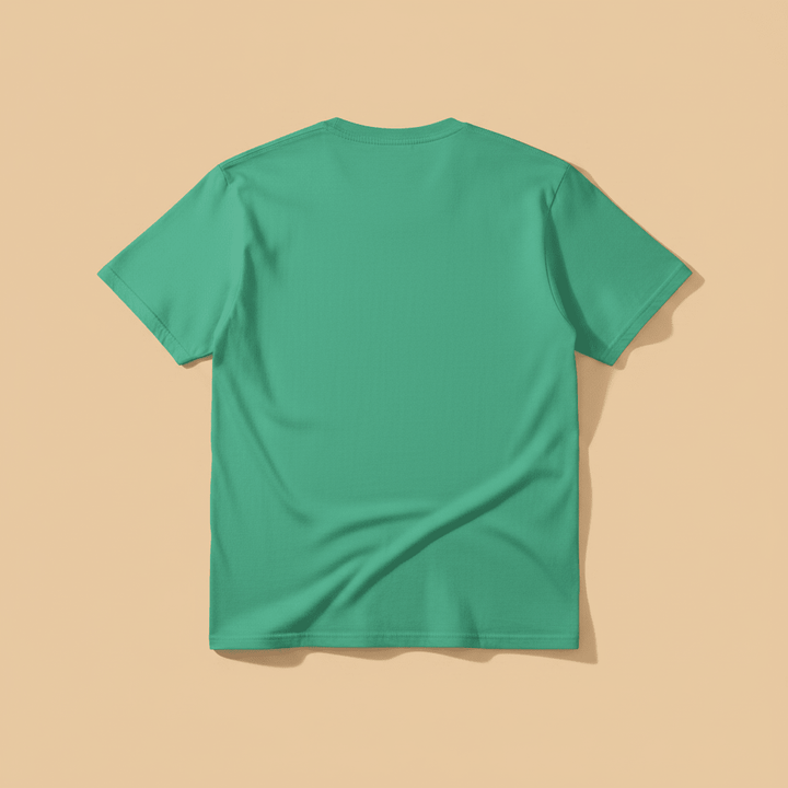 Norfolk Island Tee in Green — plain back, warm sand studio background