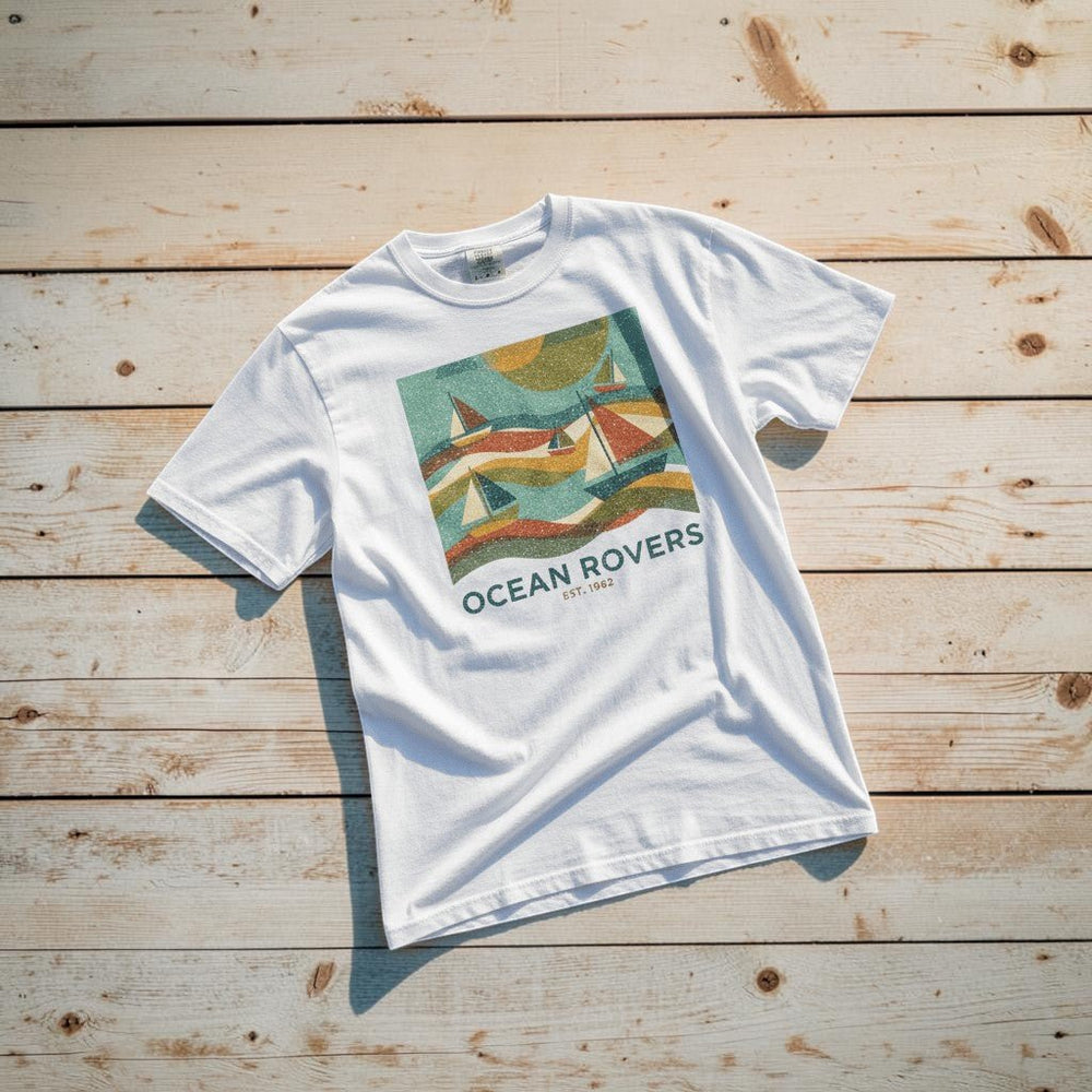 Ocean Rovers white garment-dyed tee on light cracked cement with wet marks