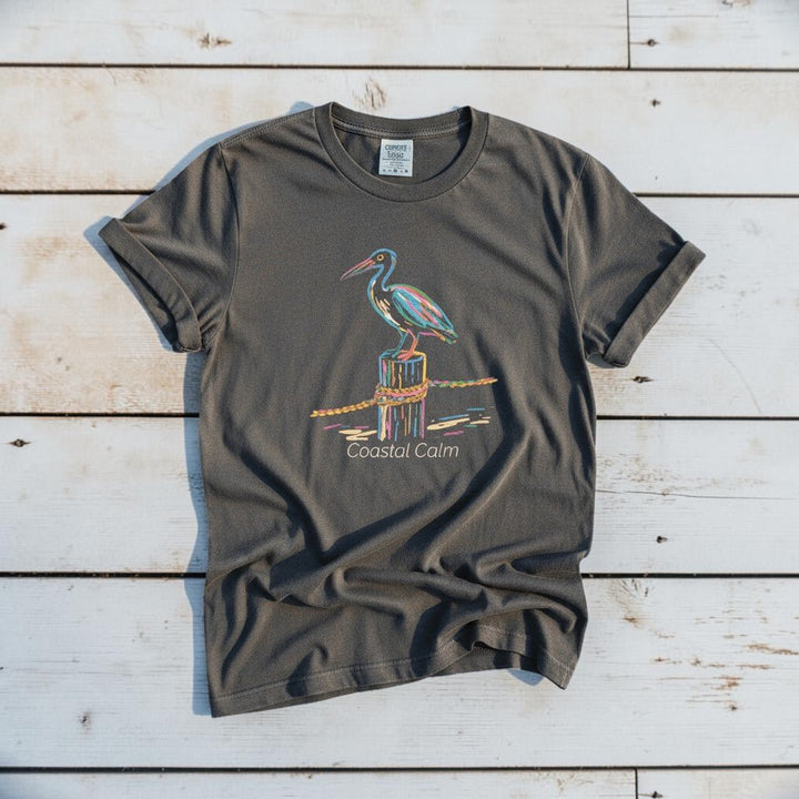 Pelican Pier Coastal Calm graphite garment-dyed tee on faded driftwood planks
