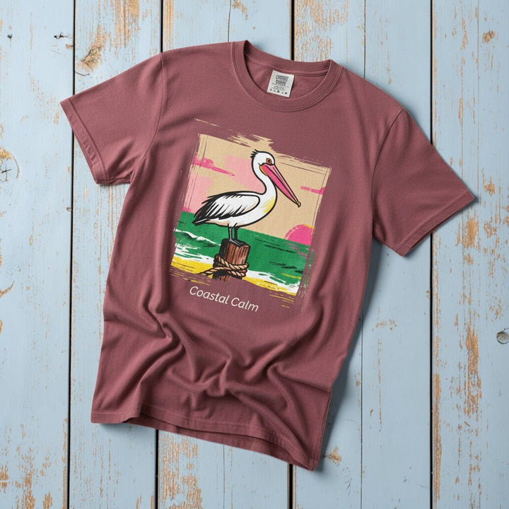 Pelican Sunset Coastal Calm brick garment-dyed tee on faded driftwood planks