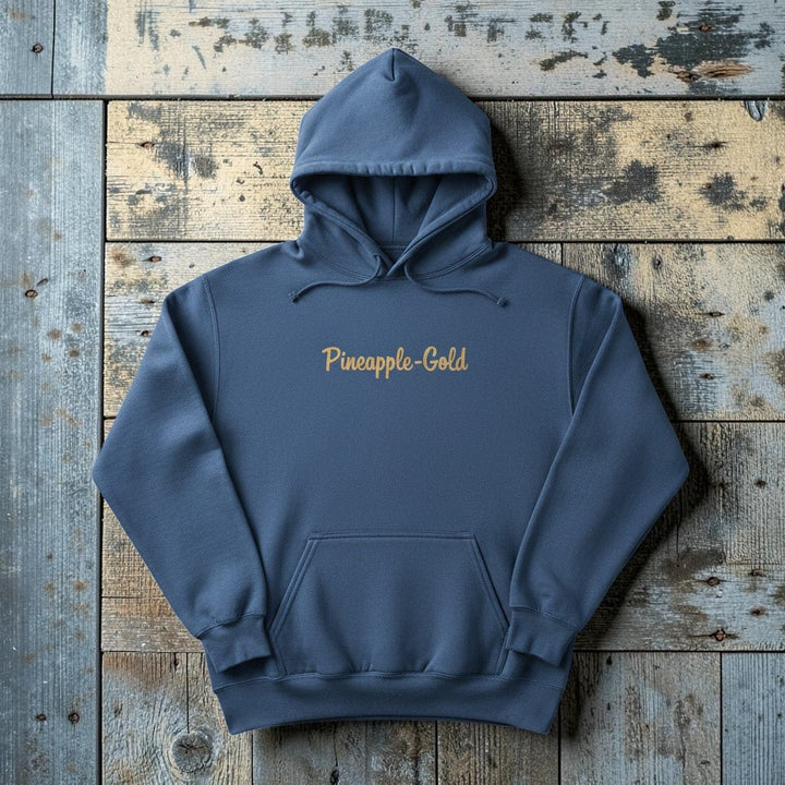 Pineapple-Gold Hoodie in True Navy — front chest graphic, warm sand studio background