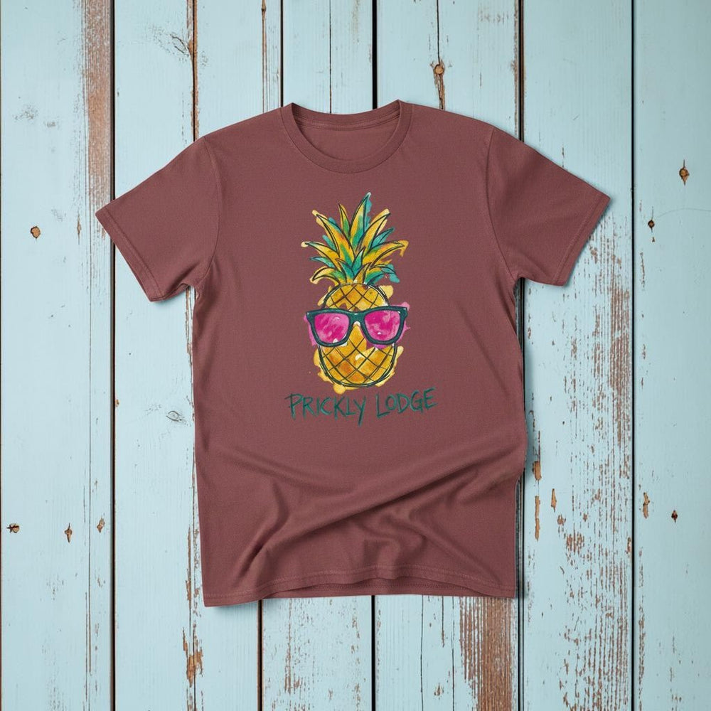 Prickly Lodge Pineapple Tee in Brick — front graphic, warm sand studio background
