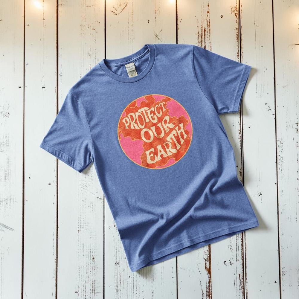Protect Our Earth Dystopia mystic blue garment-dyed tee tossed on retro-grunge driftwood planks