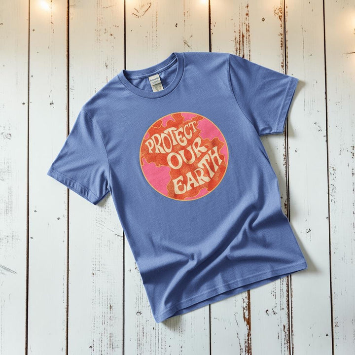 Protect Our Earth Dystopia mystic blue garment-dyed tee tossed on retro-grunge driftwood planks