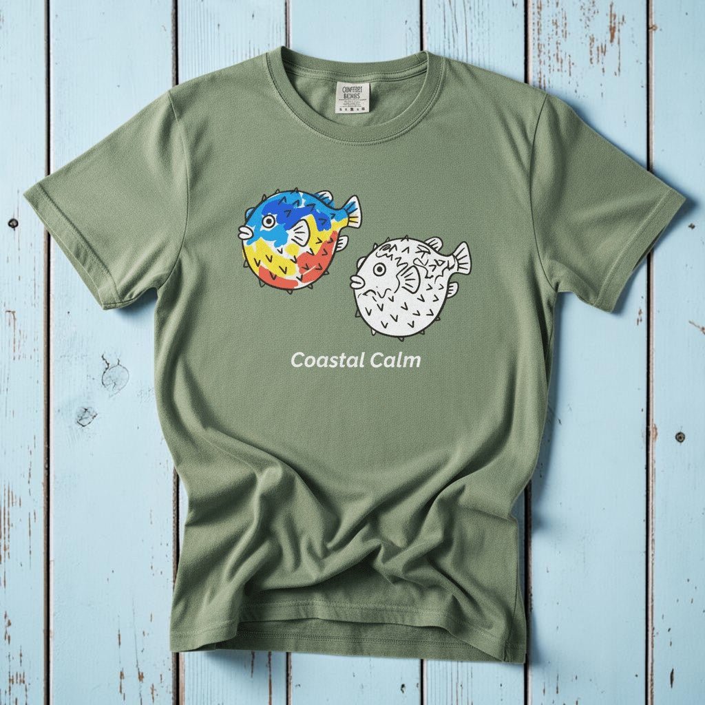 Puffer Fish Coastal Calm light green garment-dyed tee on faded driftwood planks