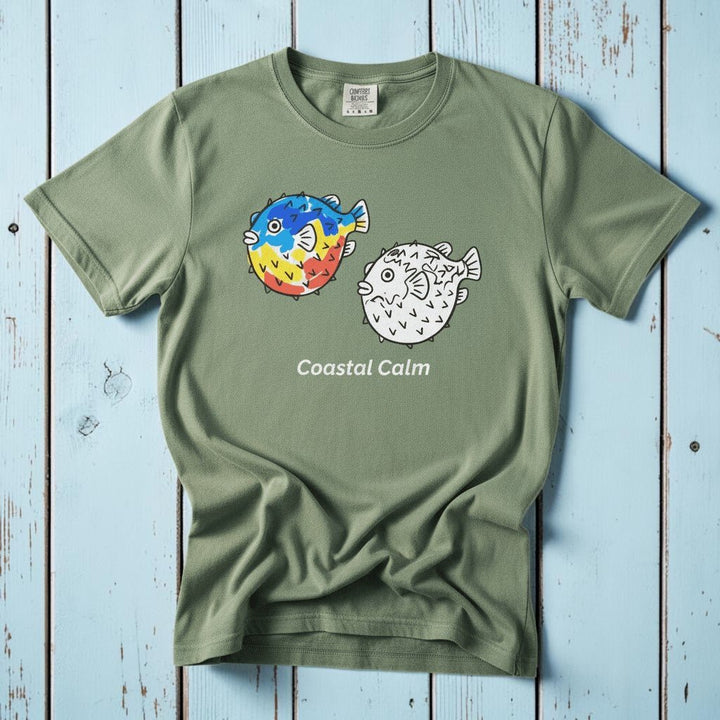 Puffer Fish Coastal Calm light green garment-dyed tee on faded driftwood planks