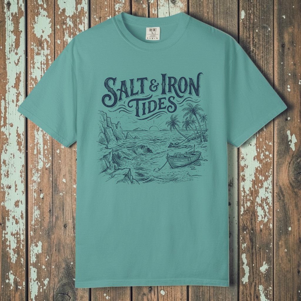 Flat lay - teal Salt &amp; Iron Tides tee on weathered driftwood planks