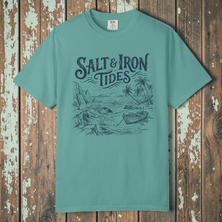 Flat lay - teal Salt &amp; Iron Tides tee on weathered driftwood planks