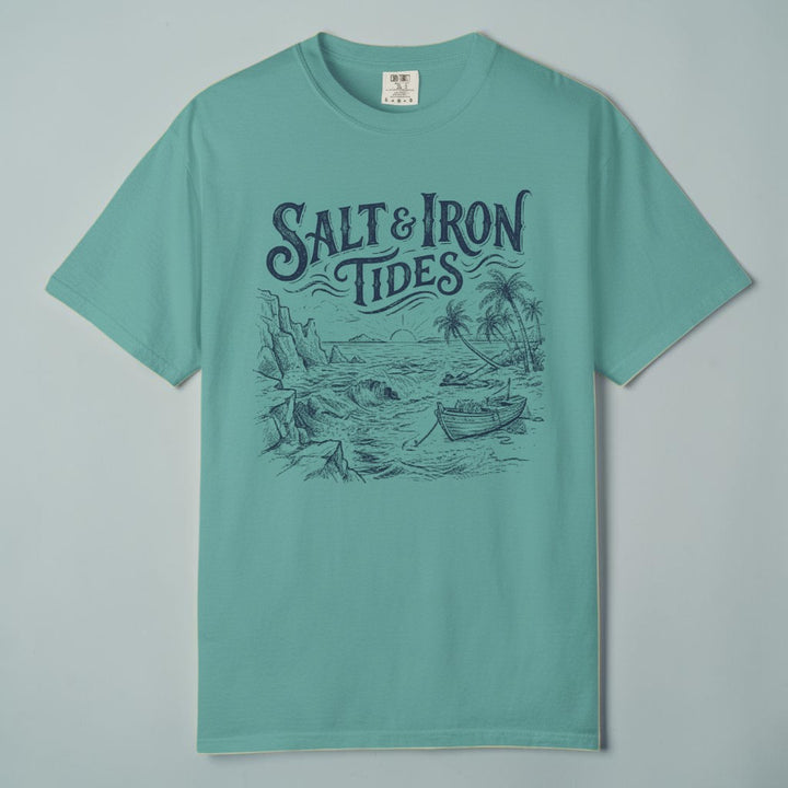 Flat lay - teal Salt &amp; Iron Tides tee on weathered driftwood planks