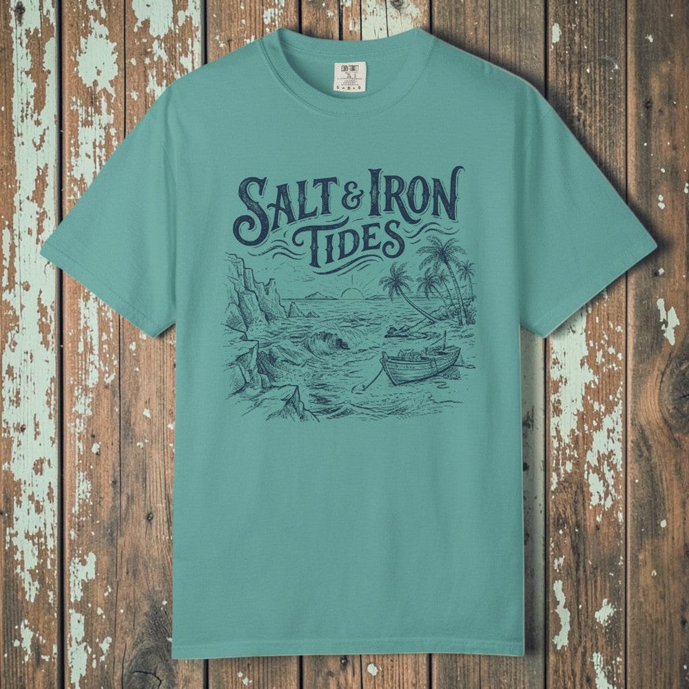 Flat lay - teal Salt & Iron Tides tee on weathered driftwood planks
