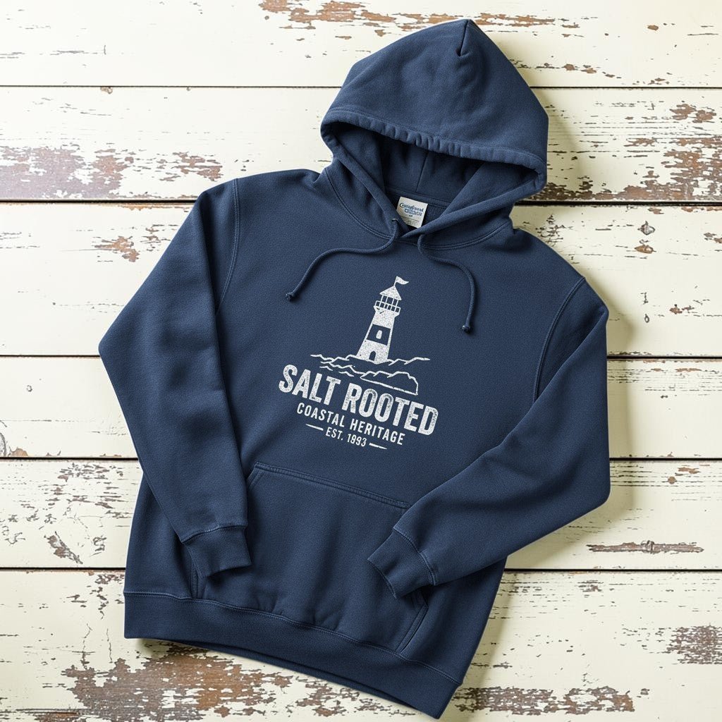 True Navy Salt Rooted lighthouse hoodie flat lay on weathered driftwood planks